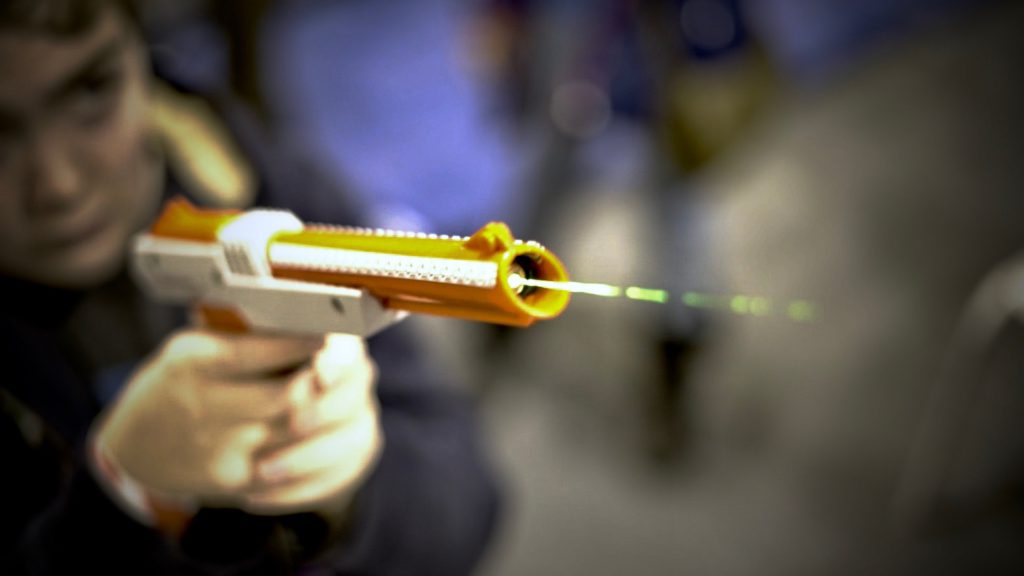 Boy firing laser gun